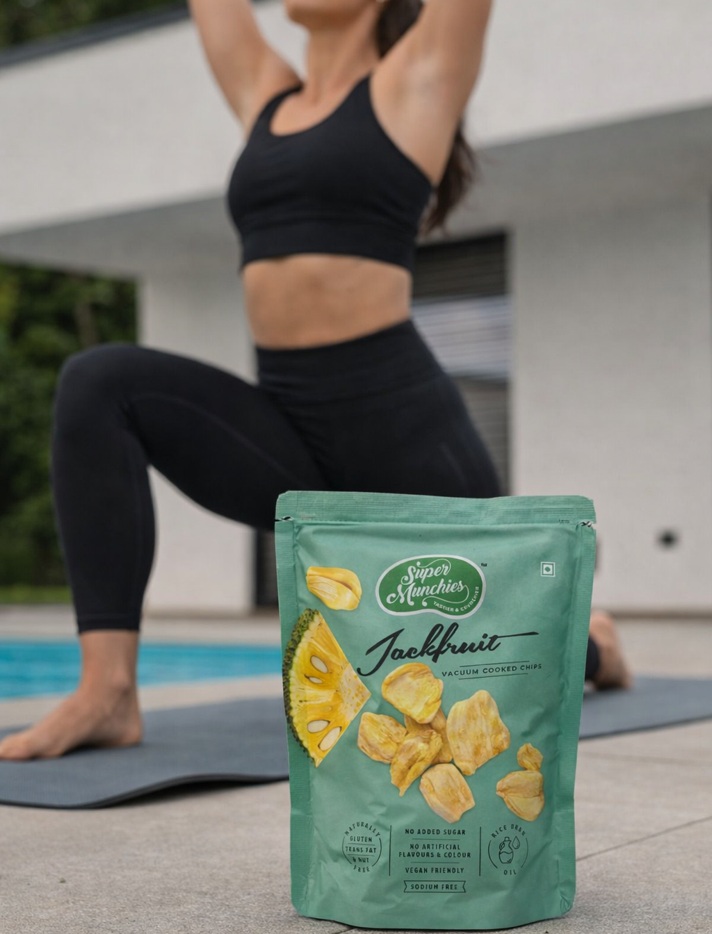 Jackfruit chips packet placed beside a yoga mat during an outdoor workout, showing a light fruit snack for active lifestyles